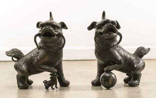 two similar sculptures of ancient Shih Tzu dogs